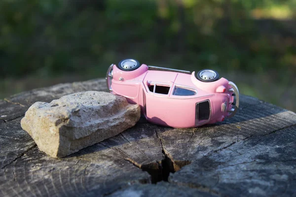 Toy car pink. Accident, insured event. Car insurance company.