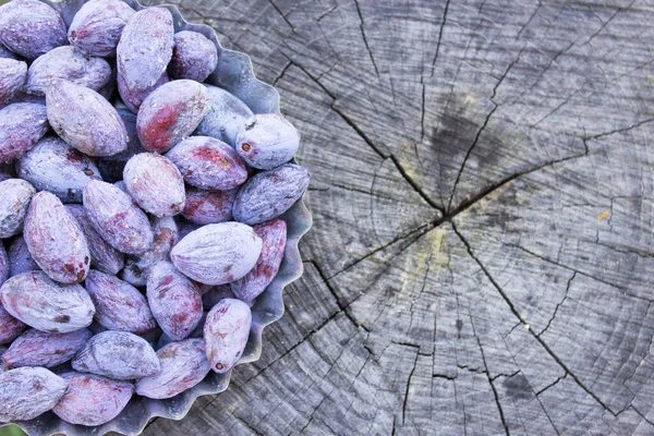 Dried plums, ugly plum on a wooden table. DIY prunes for Copy space.