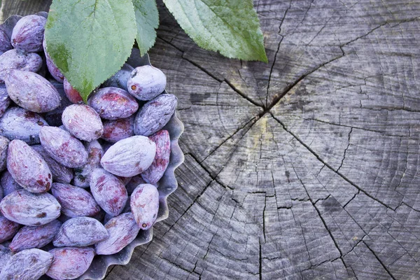 Dried plums, ugly plum on a wooden table. DIY prunes for Copy space.