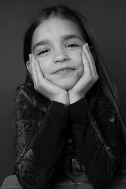 Siyah beyaz stüdyo küçük kızı çekiyor.