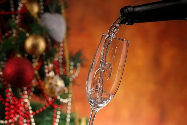 Pouring wine and christmas tree — Stock Photo, Image