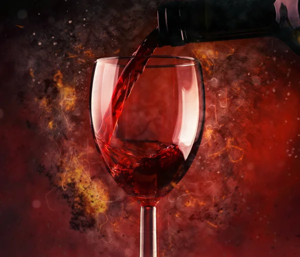 Pouring red wine and fire background — Stock Photo, Image