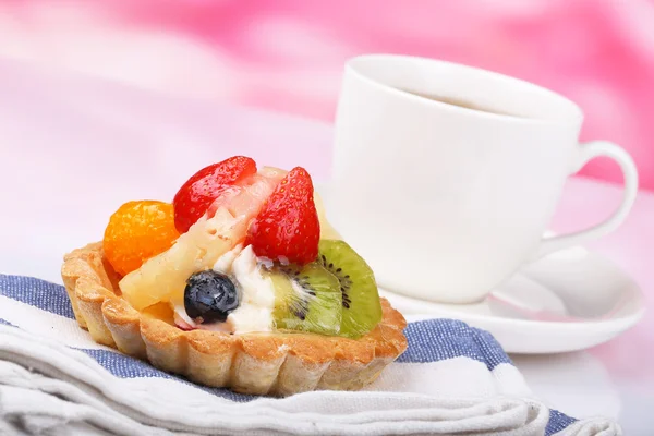 One fruit cake and teacup — Stock Photo, Image