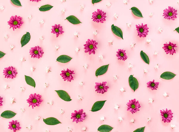 Beautiful spring pattern made of pink and white flowers and green leaves on pastel background. Seasonal natural flat lay design