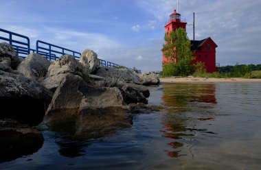 Red lighthouse on Lake Michigan clipart