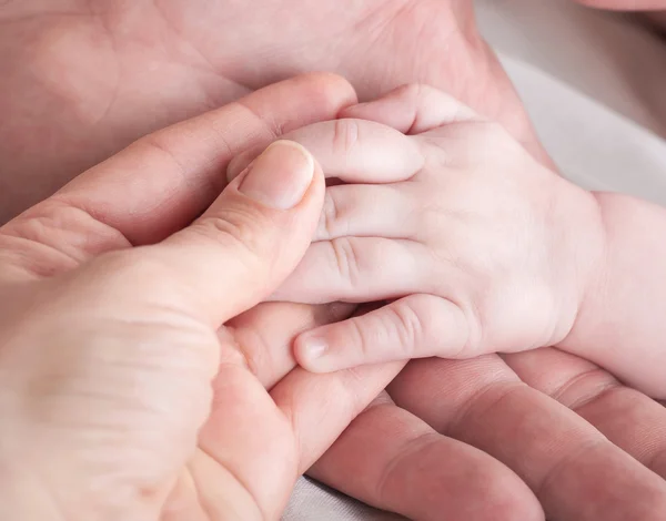 Poignées de bébé sur la mère — Photo