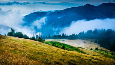 Landscape with fog and a haystack clipart