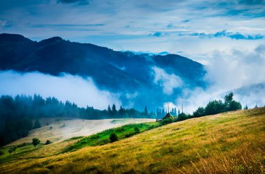 Landscape with fog and a haystack clipart