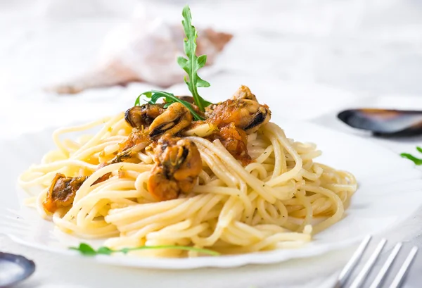 Pasta with mussels and arugula — Stock Photo, Image