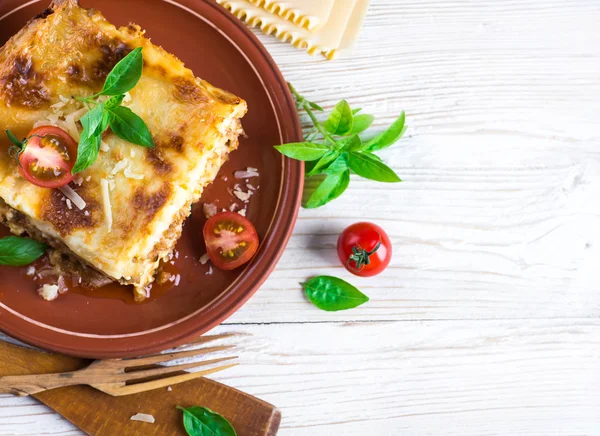 Italian lasagna and parmesan cheese — Stock Photo, Image