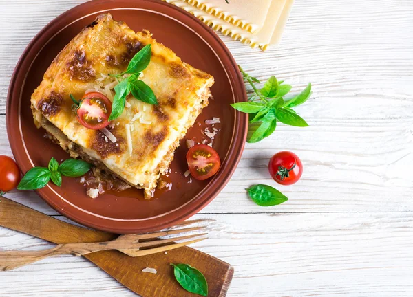 Italian lasagna and parmesan cheese — Stock Photo, Image