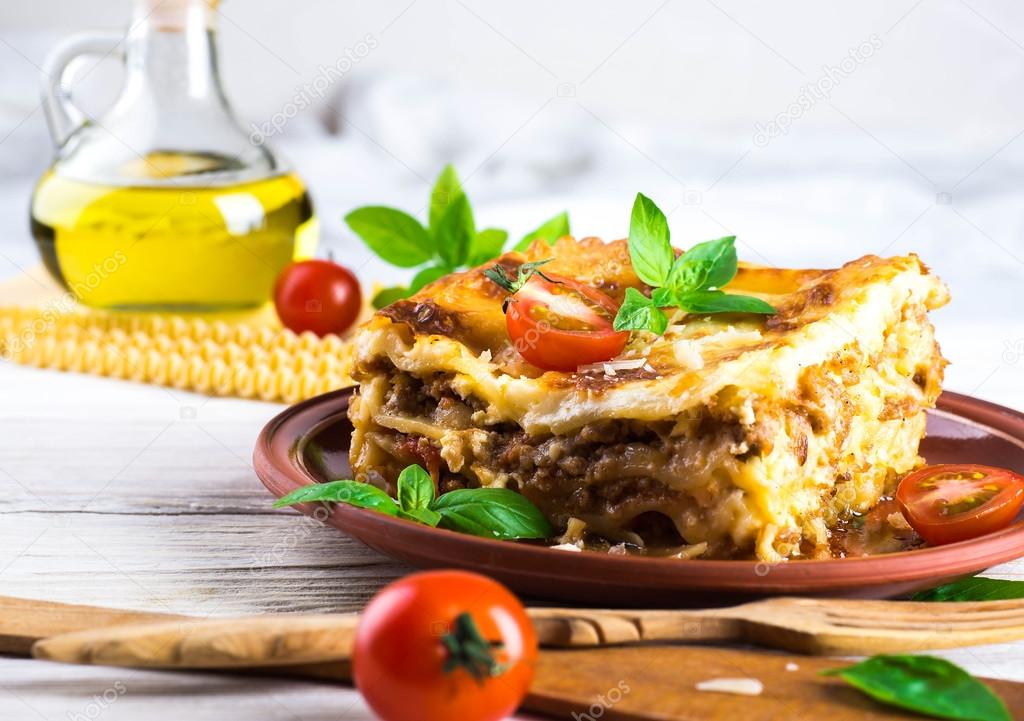 Italian lasagna and parmesan cheese — Stock Photo © seqoya 90690900