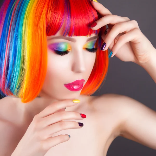 Szép nő visel színes paróka, és bemutatja a színes körmök — Stock Fotó
