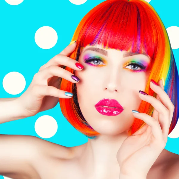 Beautiful woman wearing colorful wig and showing colorful nails — Stock Photo, Image