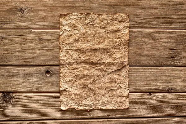 Old paper on wood background — Stock Photo, Image