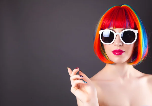 Beautiful woman wearing colorful wig — Stock Photo, Image