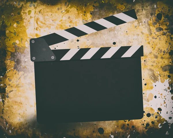 Movie clapperboard on a grunge — Stock Photo, Image