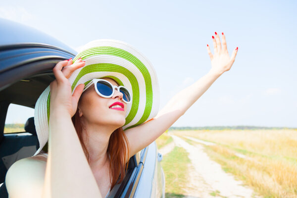 happy woman  leaning out car window