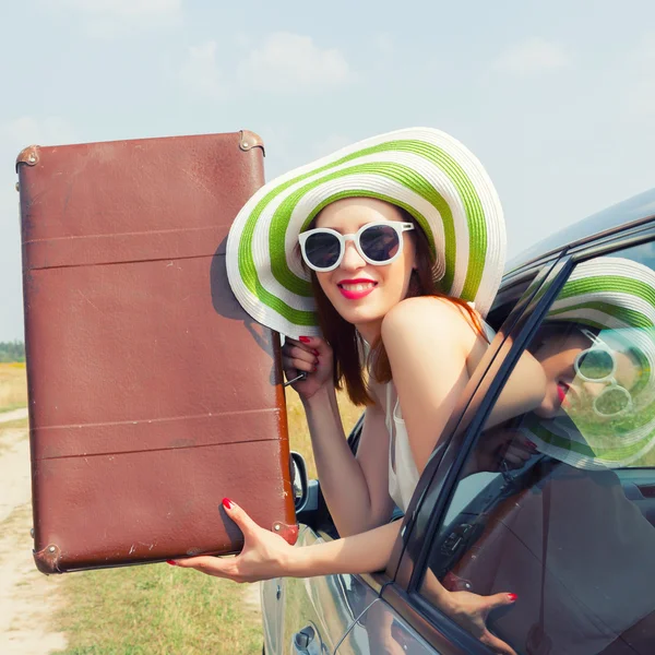 Gelukkige vrouw kijkt uit het raam van de auto — Stockfoto