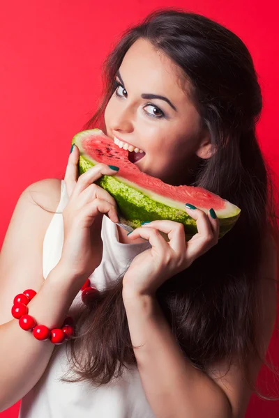 Mladá žena kousání meloun — Stock fotografie