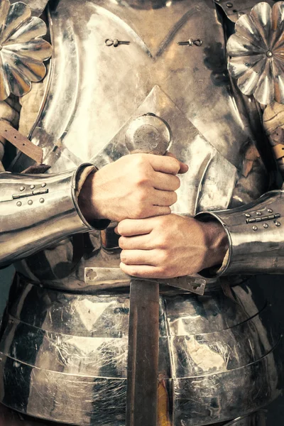 Knight wearing armor and holding sword — Stock Photo, Image