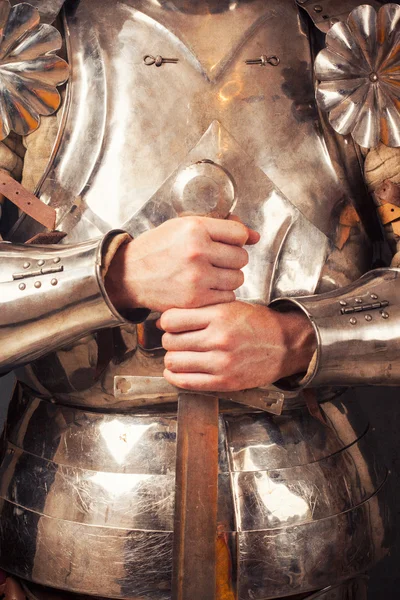 Knight wearing armor and holding sword — Stock Photo, Image