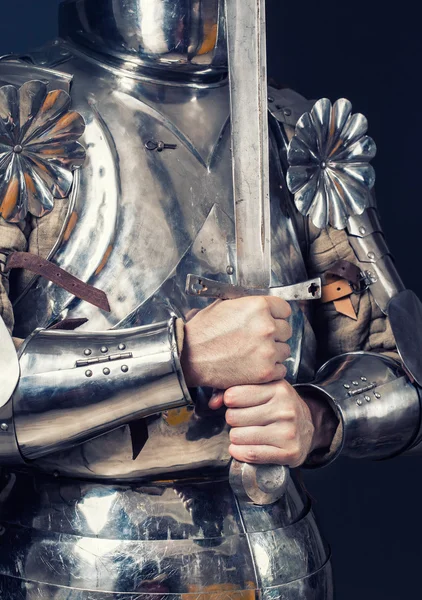 Knight wearing armor and holding sword — Stock Photo, Image