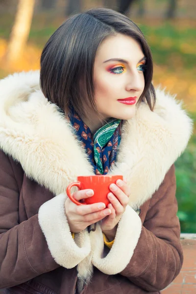 Woman  with cup in hands — Stock Photo, Image