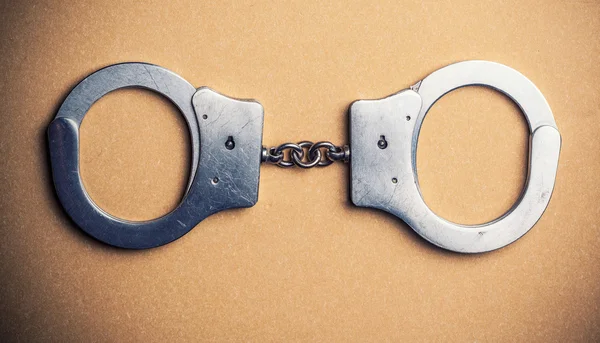 Police Handcuffs on table — Stock Photo, Image