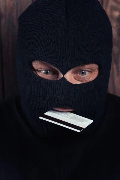 Hacker holding a credit card — Stock Photo, Image