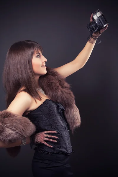 Woman holding vintage camera — Stock Photo, Image