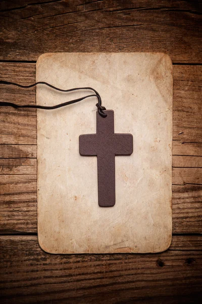 Wooden cross on paper — Stock Photo, Image