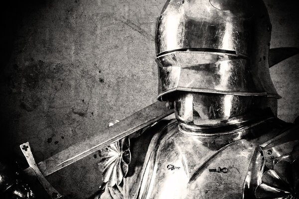 Knight wearing armor and holding two-handed sword on his shoulder