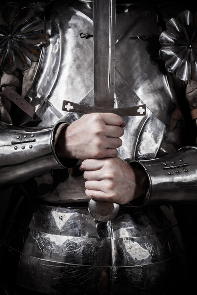 Knight wearing armor and holding two-handed sword