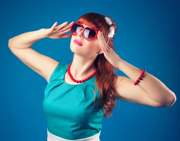 Girl posing with red heart-shaped sunglasses — Stock Photo, Image