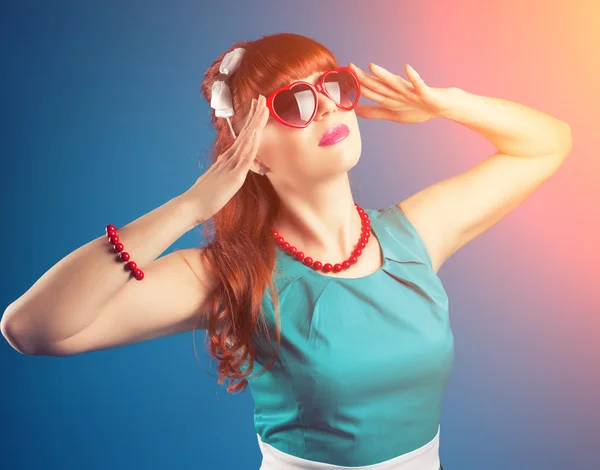 Girl posing with red heart-shaped sunglasses — Stock Photo, Image