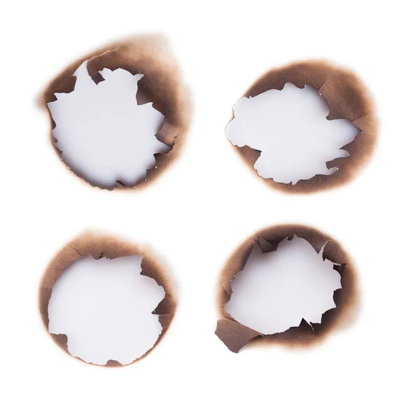 Burned holes in a paper — Stock Photo, Image