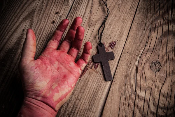 Old cross and bloody hand — Stock Photo, Image