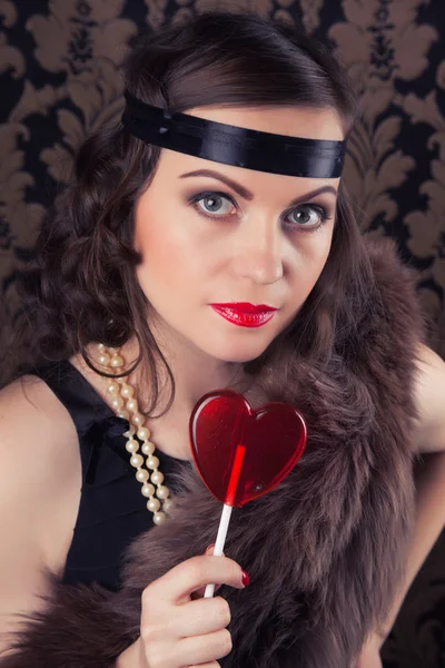 Woman holding red lollipop — Stock Photo, Image