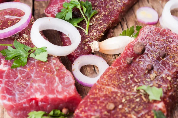 Raw beef steak with onions — Stock Photo, Image