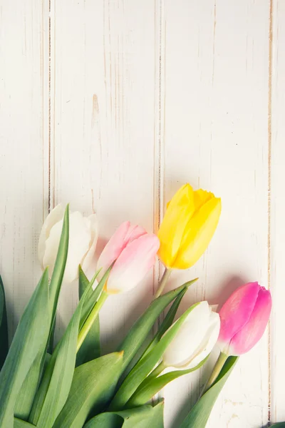 Boeket van tulpen op een houten achtergrond — Stockfoto