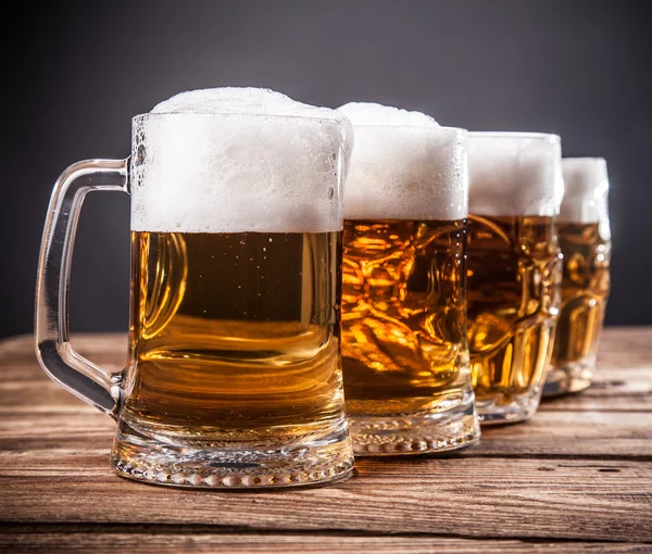 Row of mugs of beer — Stock Photo, Image