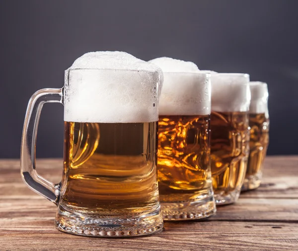 Row of mugs of beer — Stock Photo, Image
