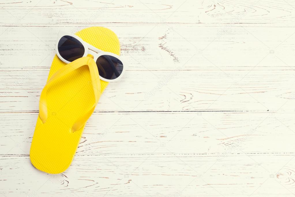 Yellow flip flop and sunglasses