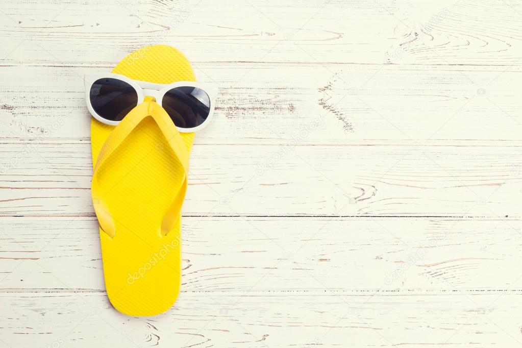 Yellow flip flop and sunglasses