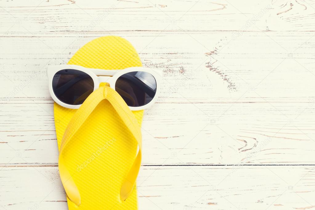 Yellow flip flop and sunglasses