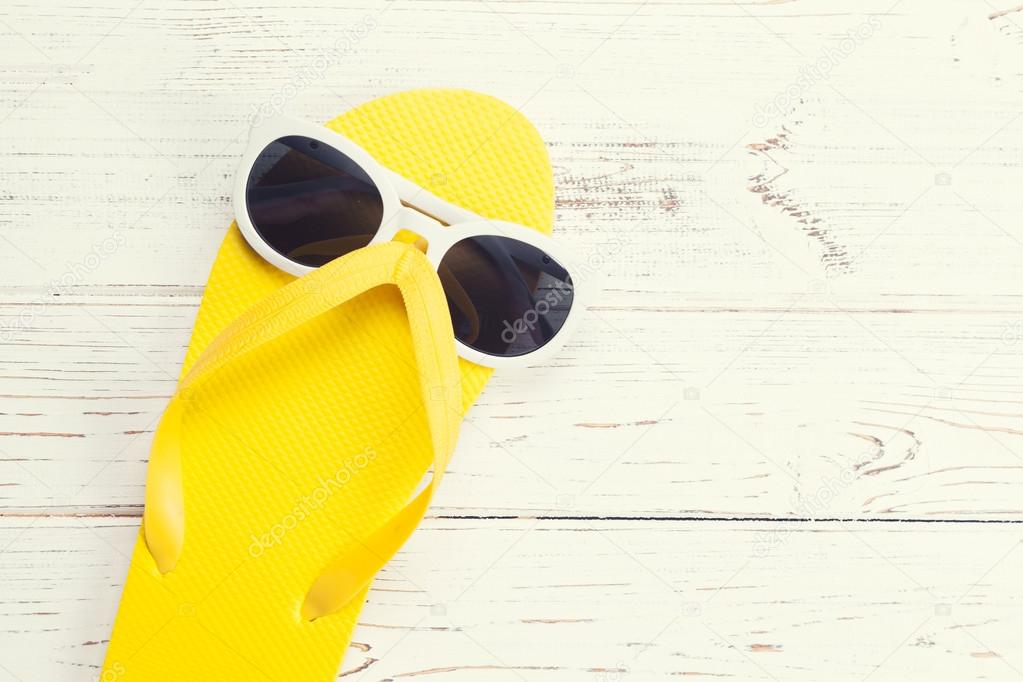 Yellow flip flop and sunglasses