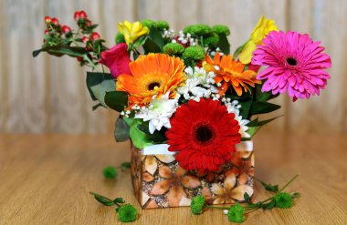 Sepette bir buket renkli çiçek var.