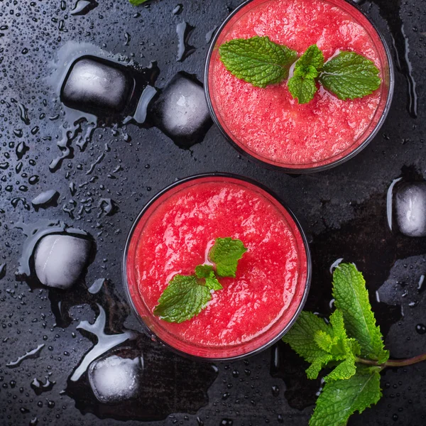 Bevanda rossa di anguria con zecca su un tavolo grunge — Foto Stock