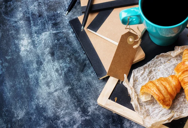 İş kırtasiye kruvasan kupa kahve grunge yazı tahtası üzerinde